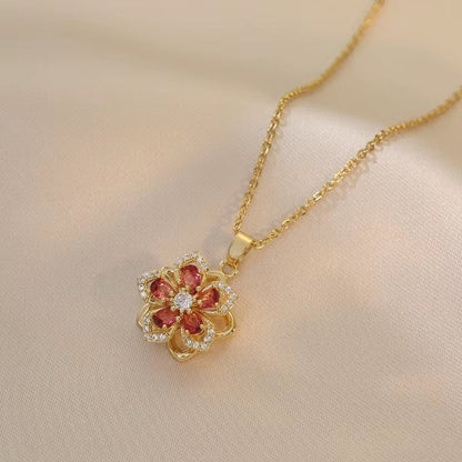Rosavina goldfarbene Halskette mit Blumenanhänger aus Zirkonia und roten Steinen, hochwertig und elegant.